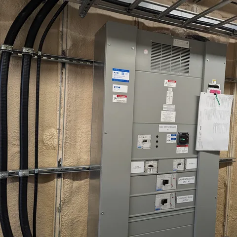 A distribution switchboard with feeder cables run in on strut and labelled breaker sections.